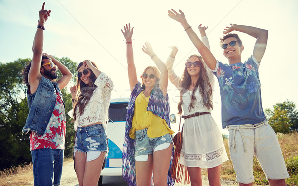 happy young hippie friends dancing outdoors Stock photo © dolgachov