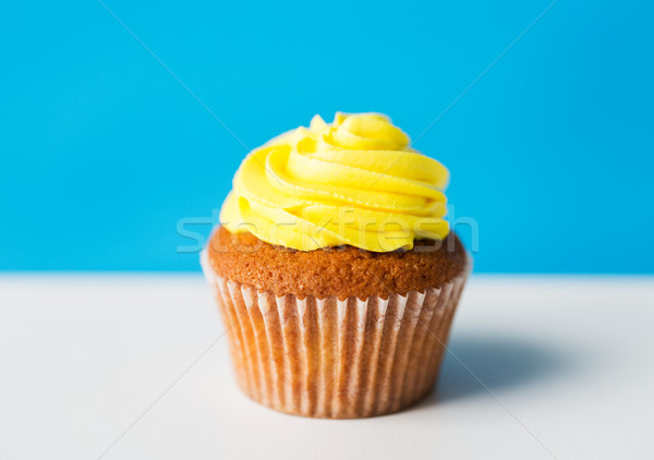 close up of cupcake or muffin with icing on table Stock photo © dolgachov