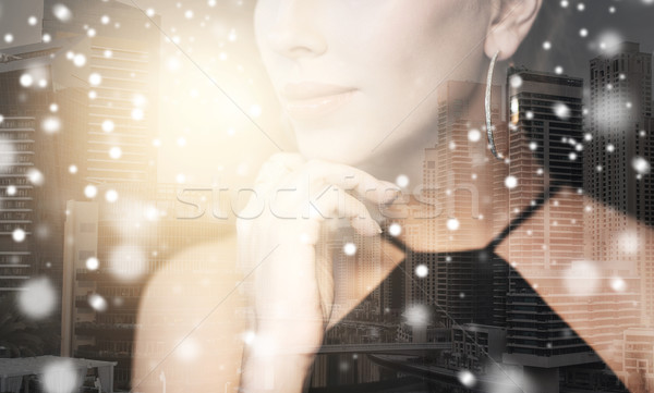 beautiful woman with jewelry over city and snow Stock photo © dolgachov