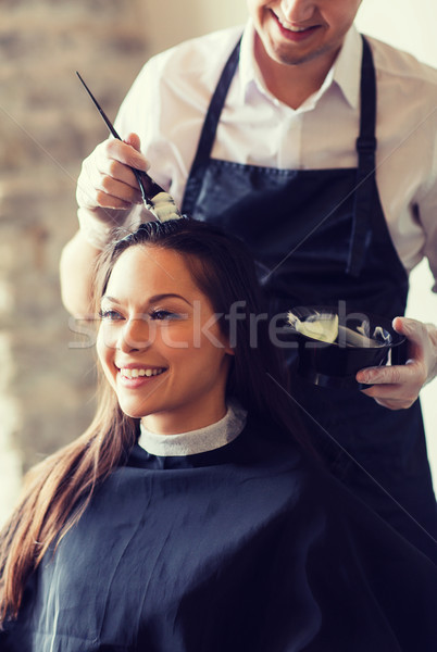 happy woman with stylist coloring hair at salon Stock photo © dolgachov