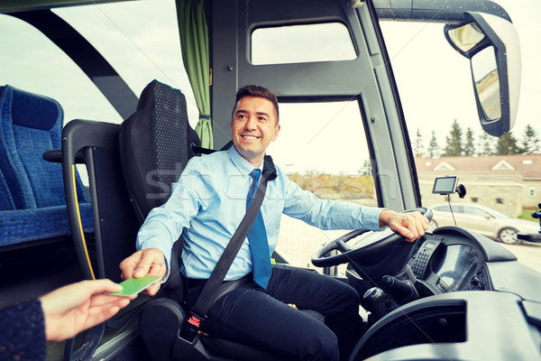 bus driver taking ticket or card from passenger Stock photo © dolgachov