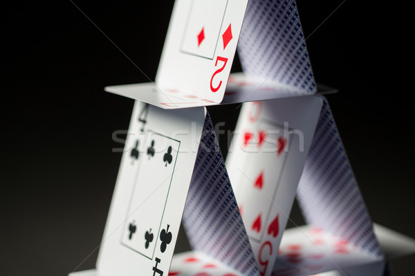 close up of house of playing cards over black Stock photo © dolgachov