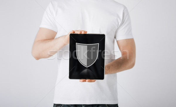 man with antivirus program icon on tablet pc Stock photo © dolgachov