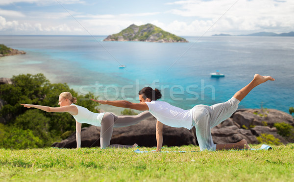 happy couple making yoga exercises outdoors Stock photo © dolgachov