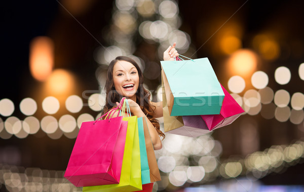 woman in red dress with colorful shopping bags Stock photo © dolgachov