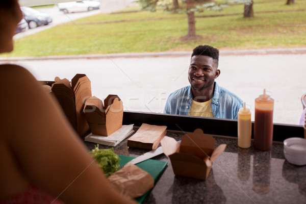 african american man ordering wok at food truck Stock photo © dolgachov