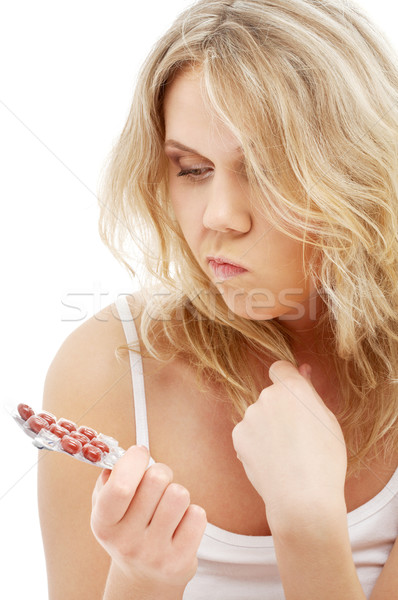 anxious blond with red pills Stock photo © dolgachov