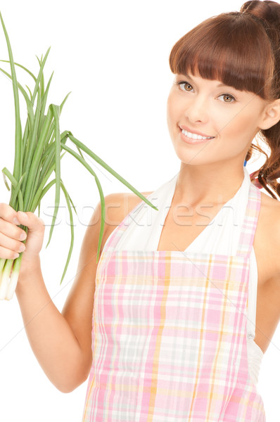 beautiful housewife with spring onions over white Stock photo © dolgachov