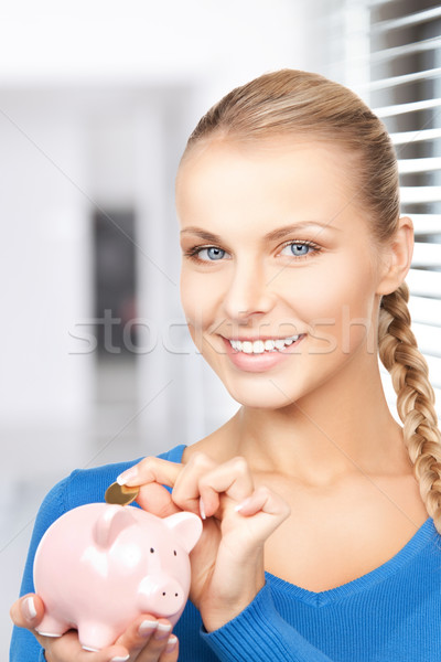 lovely woman with piggy bank and money Stock photo © dolgachov