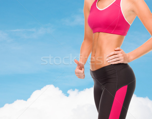 close up of female abs and hand showing thumbs up Stock photo © dolgachov