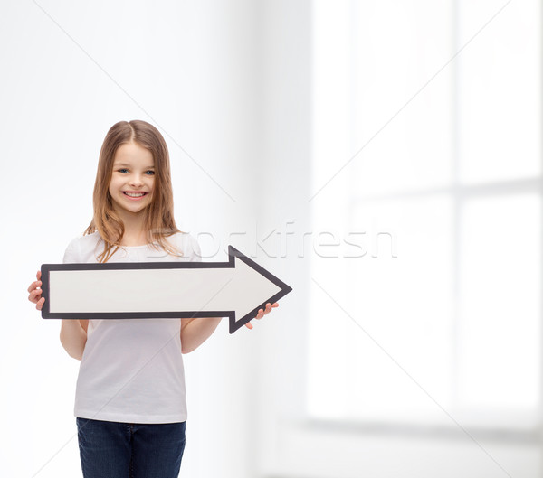 Stock photo: smiling girl with blank arrow pointing right