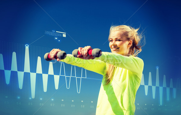 sporty woman with light dumbbells outdoors Stock photo © dolgachov