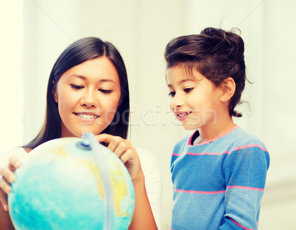 mother and daughter with globe Stock photo © dolgachov