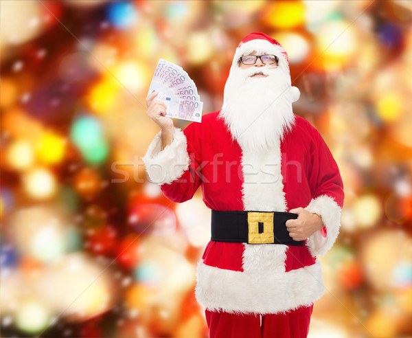 man in costume of santa claus with euro money Stock photo © dolgachov