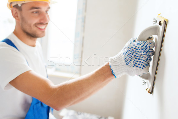 smiling builder with grinding tool indoors Stock photo © dolgachov