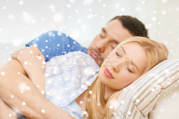 sleeping couple lying on sofa and hugging at home Stock photo © dolgachov