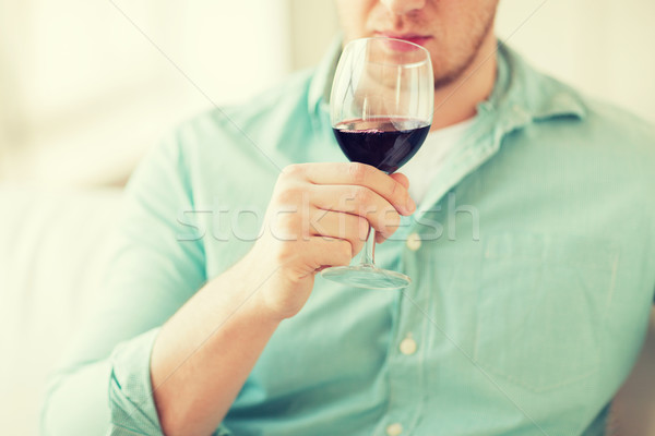 close up of man drinking wine at home Stock photo © dolgachov