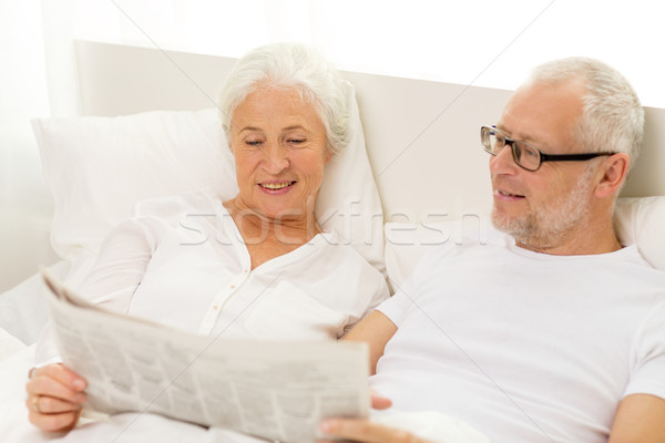 happy senior couple with newspaper in bed Stock photo © dolgachov