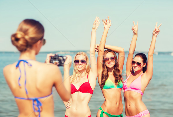 Stock photo: group of smiling women photographing on beach