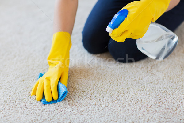 close up of woman with cloth cleaning carpet Stock photo © dolgachov