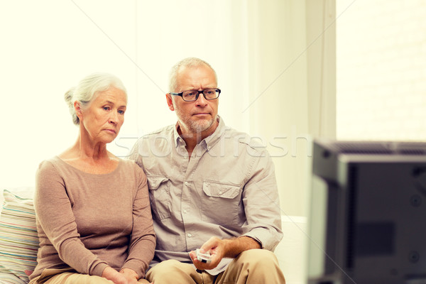 senior couple watching tv at home Stock photo © dolgachov
