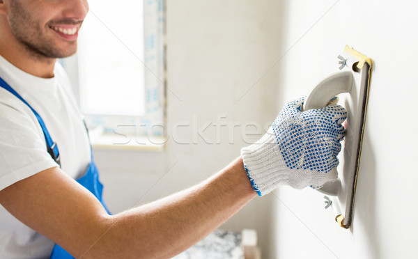 close up of builder working with grinding tool Stock photo © dolgachov