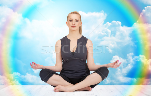 happy young woman meditating in yoga lotus pose Stock photo © dolgachov