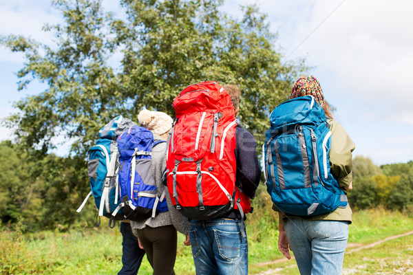 group of friends with backpacks hiking Stock photo © dolgachov