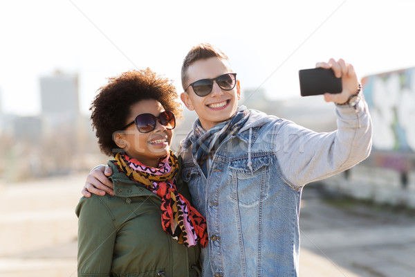 happy teenage friends in shades taking selfie Stock photo © dolgachov