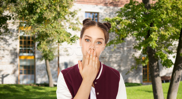 confused student girl covering her mouth by hand Stock photo © dolgachov