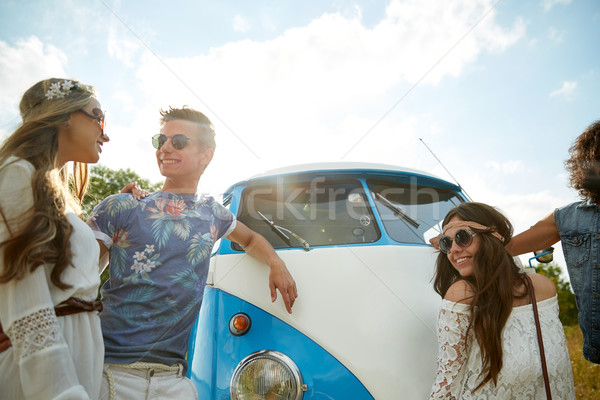 smiling young hippie friends over minivan car Stock photo © dolgachov