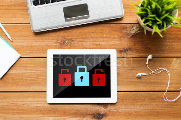 Stock photo: close up of tablet pc computer on wooden table