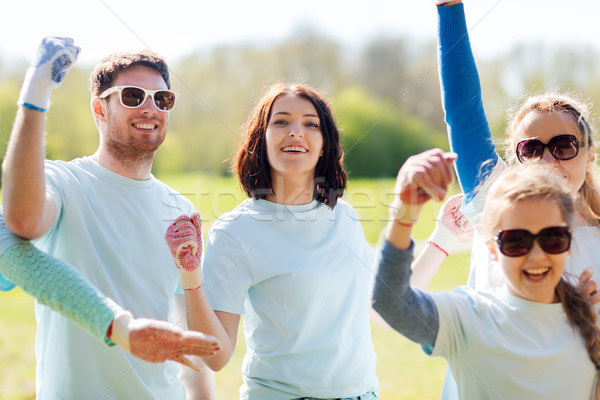 group of volunteers celebrating success in park Stock photo © dolgachov