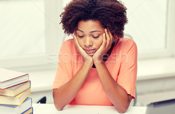 bored african american woman doing homework home Stock photo © dolgachov