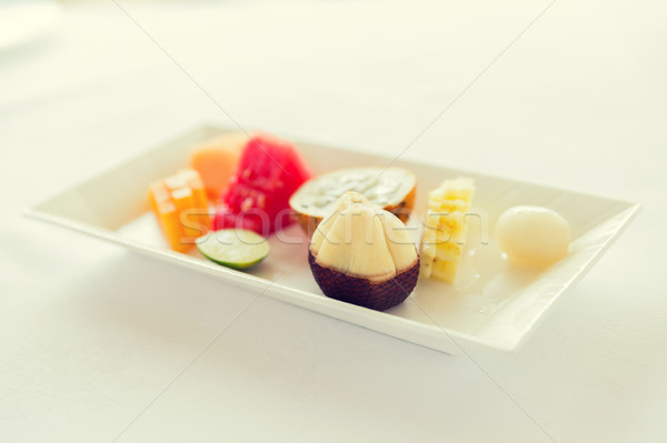 plate of fresh juicy fruit dessert at restaurant Stock photo © dolgachov