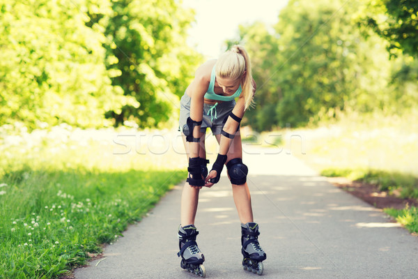 happy young woman in rollerskates riding outdoors Stock photo © dolgachov