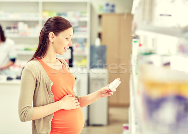 happy pregnant woman with medication at pharmacy Stock photo © dolgachov