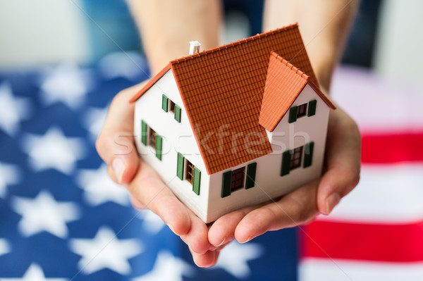 Közelkép kezek tart ház amerikai zászló állampolgárság Stock fotó © dolgachov