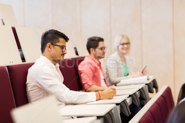 group of students with notebooks in lecture hall Stock photo © dolgachov