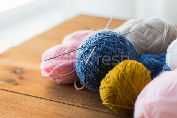 knitting needles and balls of yarn on wood Stock photo © dolgachov