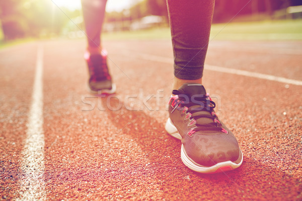 close up of woman feet running on track from back Stock photo © dolgachov