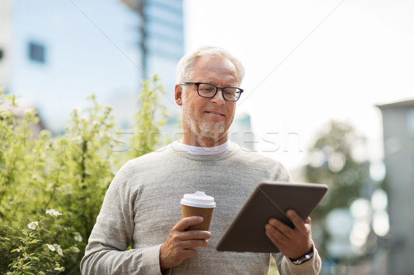 senior man with tablet pc and coffee in city Stock photo © dolgachov