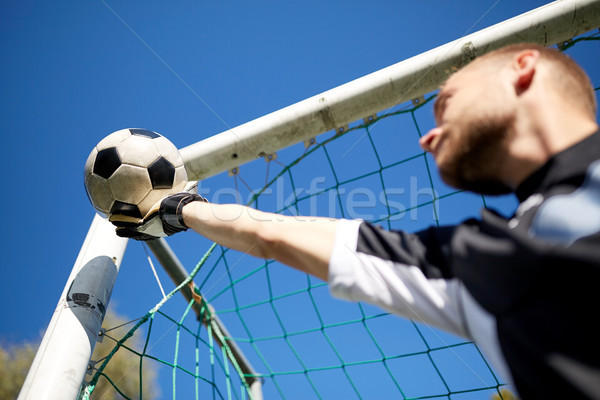 goalkeeper with ball at football goal on field Stock photo © dolgachov