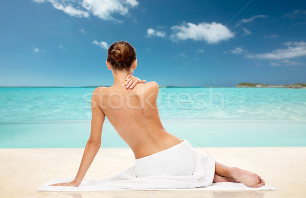 beautiful woman in towel with bare top on beach Stock photo © dolgachov