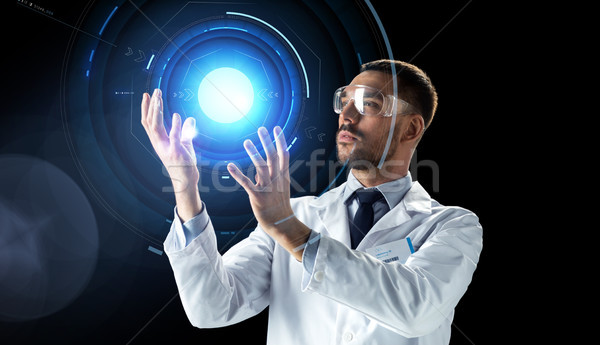 scientist in lab goggles with virtual projection Stock photo © dolgachov