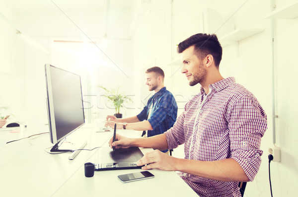 man or designer with computer and tablet at office Stock photo © dolgachov