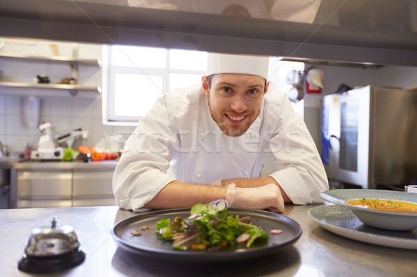 happy male chef cooking food at restaurant kitchen Stock photo © dolgachov