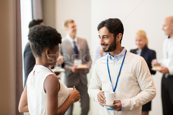 business people with conference badges and coffee Stock photo © dolgachov