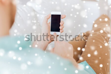 Heureux jeune femme smartphone lit maison technologie [[stock_photo]] © dolgachov