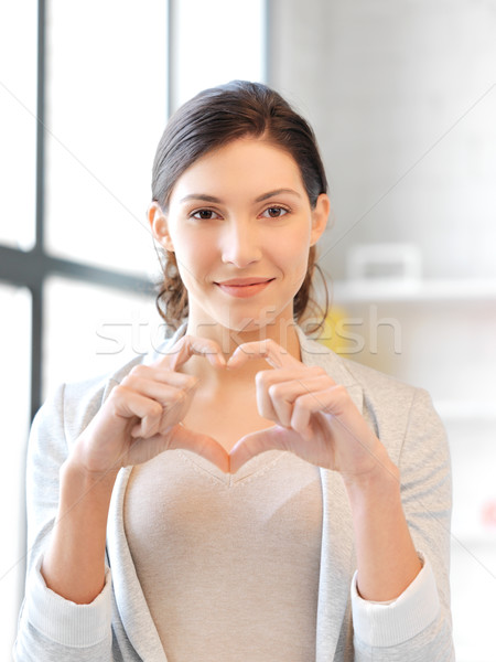 happy woman making heart gesture Stock photo © dolgachov